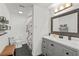 Clean bathroom featuring a stylish vanity, decorative mirror and tiled floors at 1410 Osceola Ct, Orlando, FL 32806