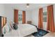 Inviting bedroom featuring windows with dramatic curtains and a decorative rug on hardwood flooring at 1410 Osceola Ct, Orlando, FL 32806