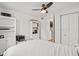 Bright bedroom with white walls, built in shelving, ceiling fan and view into the kitchen at 1410 Osceola Ct, Orlando, FL 32806