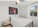 This bedroom has neutral walls, a ceiling fan and natural light from the single window at 1410 Osceola Ct, Orlando, FL 32806