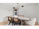 Bright dining room showcasing a modern light fixture and a large table with stylish chairs at 1410 Osceola Ct, Orlando, FL 32806