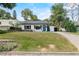 Charming white home with a neatly landscaped yard and a welcoming blue front door at 1410 Osceola Ct, Orlando, FL 32806