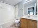 Bathroom features a bathtub, shower, toilet, and vanity with a sink and mirror at 15323 Torpoint Rd, Winter Garden, FL 34787