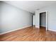 Bedroom featuring hardwood floors, a closet, and a light gray color scheme at 15323 Torpoint Rd, Winter Garden, FL 34787