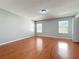 Bright bedroom with hardwood floors, gray walls, and large windows at 15323 Torpoint Rd, Winter Garden, FL 34787