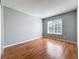 Bedroom featuring hardwood floors and a large window at 15323 Torpoint Rd, Winter Garden, FL 34787