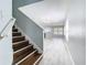 Entryway with wooden stairs, light gray walls, white trim and durable laminate flooring at 15323 Torpoint Rd, Winter Garden, FL 34787