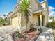 Exterior view of home featuring desert landscaping, a green front door, and a decorative water feature at 15323 Torpoint Rd, Winter Garden, FL 34787