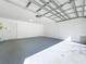 Clean, empty garage with a large open space and sealed concrete flooring at 15323 Torpoint Rd, Winter Garden, FL 34787