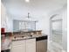 Well-lit kitchen featuring stainless steel appliances, ample countertop space, and an open view into the living room at 15323 Torpoint Rd, Winter Garden, FL 34787