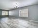 Living room with durable laminate flooring, light gray walls, white trim and a modern ceiling fan at 15323 Torpoint Rd, Winter Garden, FL 34787