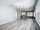 Bright living room featuring laminate flooring, light gray walls, and an archway at 15323 Torpoint Rd, Winter Garden, FL 34787