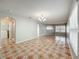 Open living space with tile flooring and neutral walls, leading to kitchen and laundry room at 15323 Torpoint Rd, Winter Garden, FL 34787