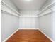 Walk-in closet with installed white wire shelving and hardwood floors at 15323 Torpoint Rd, Winter Garden, FL 34787