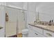 Bright bathroom with granite vanity top, a mirror and a glass-enclosed shower at 15772 Murcott Harvest Loop, Winter Garden, FL 34787