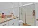 Bright bathroom with granite vanity top, a mirror and a glass-enclosed shower at 15772 Murcott Harvest Loop, Winter Garden, FL 34787