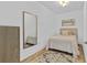 Bedroom featuring carpet, a gold mirror, and a 'Gathering' decorative sign at 15772 Murcott Harvest Loop, Winter Garden, FL 34787