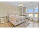 Bright bedroom featuring neutral colors, a large bed, and an abundance of natural light at 15772 Murcott Harvest Loop, Winter Garden, FL 34787