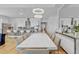 Bright dining area with modern chandelier and seating for ten is perfect for entertaining at 15772 Murcott Harvest Loop, Winter Garden, FL 34787