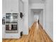 Hallway features gleaming hardwood floors and crisp white trim, leading to the front door at 15772 Murcott Harvest Loop, Winter Garden, FL 34787