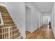 Hallway with wooden staircase, decorative molding, and a baby gate for added safety and security at 15772 Murcott Harvest Loop, Winter Garden, FL 34787