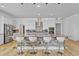 Spacious kitchen with stone island, modern appliances, and sleek white cabinetry at 15772 Murcott Harvest Loop, Winter Garden, FL 34787