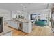 Open concept kitchen showcasing a center island with a stainless steel dishwasher and a sink at 15772 Murcott Harvest Loop, Winter Garden, FL 34787