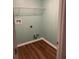 This empty closet has a wire shelf, washer/dryer hookups, and hard floors for easy cleaning at 1629 Hill Park Dr, Deltona, FL 32725