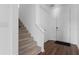 Bright entryway featuring carpeted stairs and wood flooring leading to a white front door at 1629 Hill Park Dr, Deltona, FL 32725