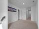 Upstairs hallway with carpeted floors, white walls, and multiple doorways at 1629 Hill Park Dr, Deltona, FL 32725