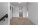 A carpeted hallway with neutral paint connects the bedrooms and bathrooms upstairs at 1629 Hill Park Dr, Deltona, FL 32725