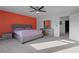 Spacious main bedroom featuring a gray bed frame, dresser, and an orange accent wall at 1629 Hill Park Dr, Deltona, FL 32725