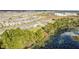 Wide aerial shot of a residential area next to a pond showing many homes with green landscaping at 17846 Adrift Rd, Winter Garden, FL 34787