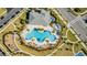 Aerial view of a community pool featuring a splashpad, seating areas, playground, and manicured landscaping at 17846 Adrift Rd, Winter Garden, FL 34787