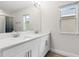 Bathroom featuring double vanity with a large mirror and natural light at 17846 Adrift Rd, Winter Garden, FL 34787