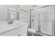 Modern bathroom featuring a tiled glass enclosed shower, white vanity, and stylish fixtures at 17846 Adrift Rd, Winter Garden, FL 34787