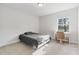 Bright bedroom featuring a cozy bed, desk area with a chair, and natural light from the window at 17846 Adrift Rd, Winter Garden, FL 34787