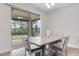 Bright dining area with modern table set and sliding glass doors leading to the outdoor patio at 17846 Adrift Rd, Winter Garden, FL 34787