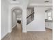 Bright foyer features elegant archways, staircase with iron railings and wood-look tile flooring at 17846 Adrift Rd, Winter Garden, FL 34787