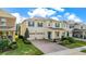 Aerial view showcasing a charming two-story home with a brick driveway, manicured lawn, and a welcoming front porch at 17846 Adrift Rd, Winter Garden, FL 34787