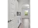 Hallway with wood-style tile flooring and stylish archway into a dining area at 17846 Adrift Rd, Winter Garden, FL 34787