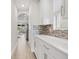 Hallway with white cabinets and a view towards an open kitchen and dining room at 17846 Adrift Rd, Winter Garden, FL 34787