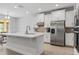 Bright open kitchen featuring an island, stainless steel appliances, white cabinetry and tile backsplash at 17846 Adrift Rd, Winter Garden, FL 34787