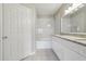 Bright bathroom featuring white cabinets, granite countertops, and a combined shower and tub at 202 E South St # 5037, Orlando, FL 32801