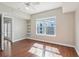 Bedroom featuring hardwood floors, large window, shelving, and a ceiling fan at 202 E South St # 5037, Orlando, FL 32801