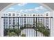 View from a balcony looking out to the building and courtyard with lush landscaping below at 202 E South St # 5037, Orlando, FL 32801