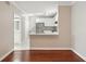 View of the kitchen from the living room, featuring white cabinets and stainless-steel appliances at 202 E South St # 5037, Orlando, FL 32801