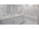 Modern bathroom featuring double sinks, quartz counters and a tub with shower at 205 Famagusta Dr, Davenport, FL 33896