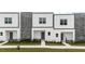 These modern townhouses are shown with gray and white exteriors, complemented by stylish stone accents at 205 Famagusta Dr, Davenport, FL 33896