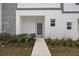 Contemporary home entrance with stone accents and modern landscaping at 205 Famagusta Dr, Davenport, FL 33896